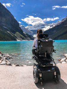 Tori is sitting in her wheelchair looking out at the beauty of Lake Louise