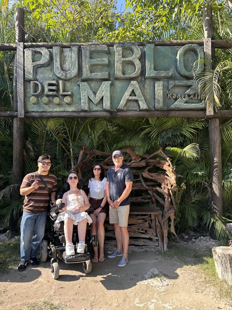 Tori and her family in front of the Pueblo Del Maiz entrance sign