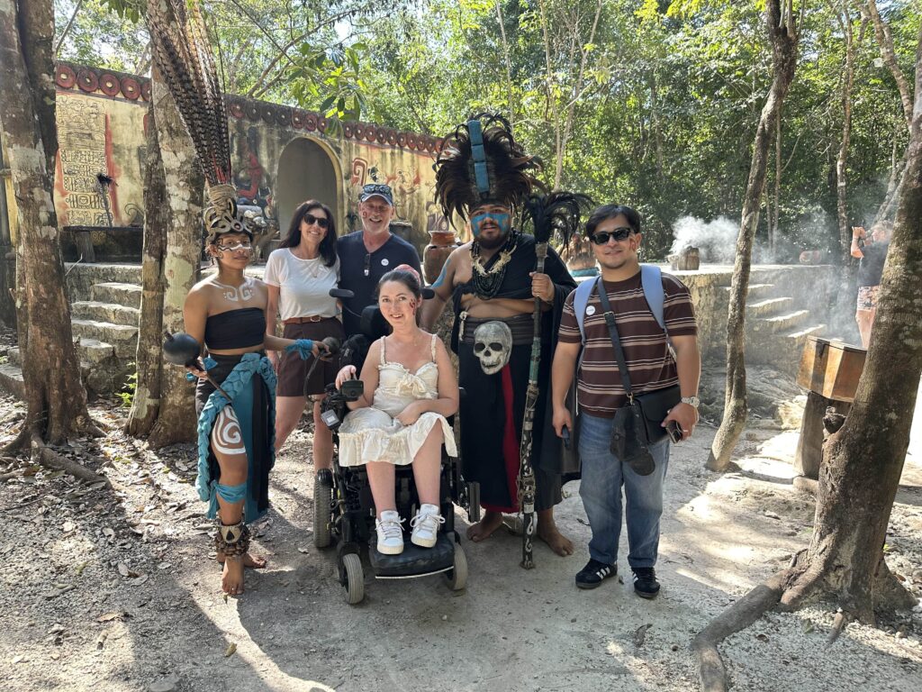 Tori and her family with performers after the cultural ceremony