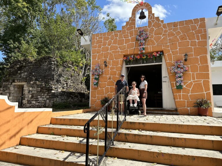 Tori and family in front of El Cedral church on wheelchair accessible shore excursion in Cozumel Mexico