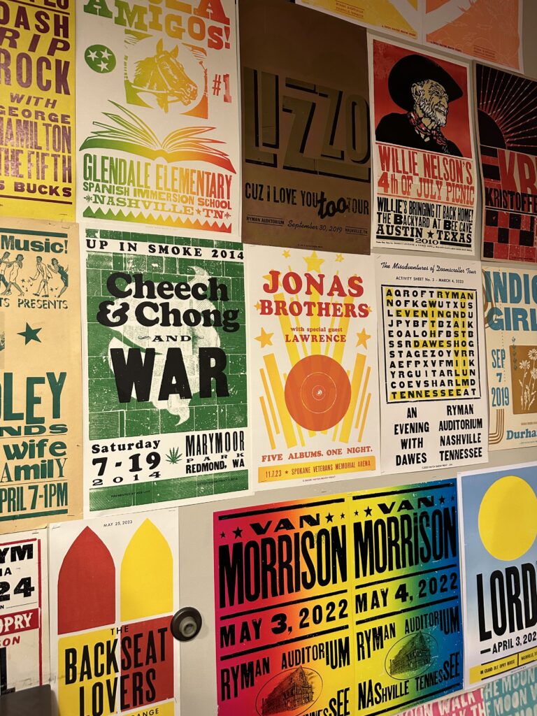 A wall collage of colourful letter press posters that have been designed for live musicians to advertise their concerts