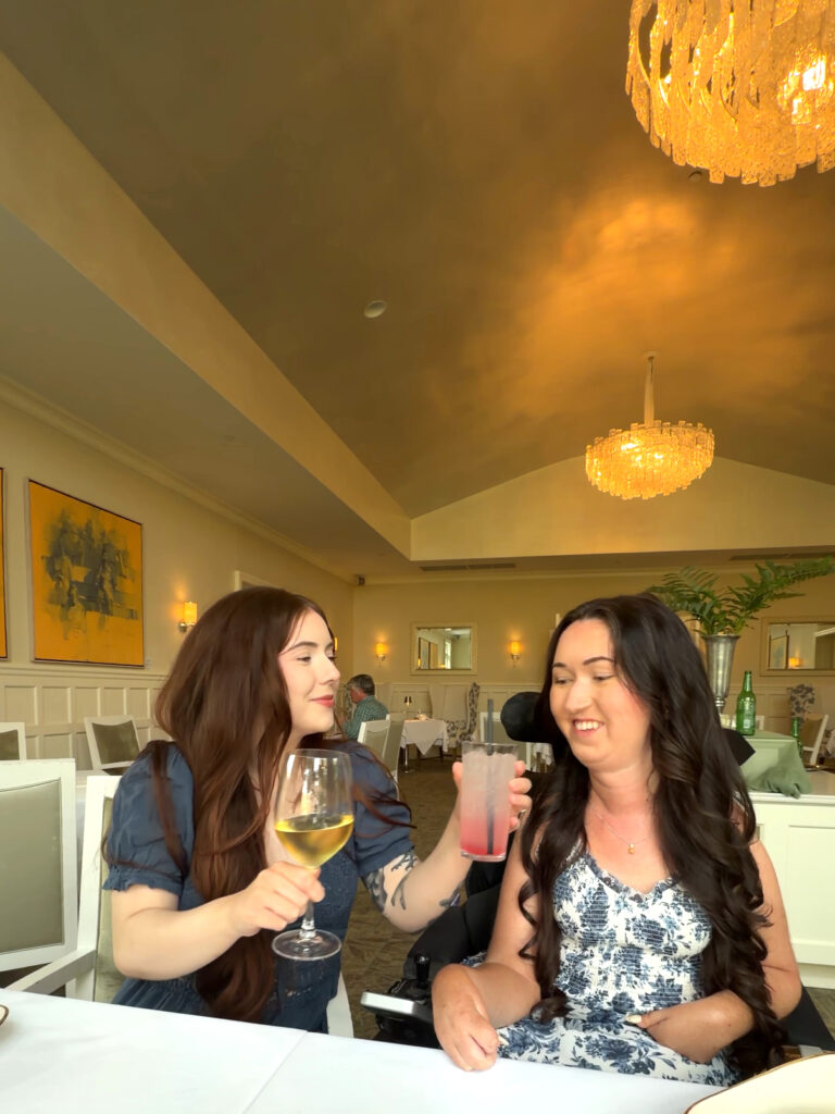  Tori Hunter, a wheelchair user and disabled travel blogger, toasting with a friend over cocktails at the restaurant inside The Bruce Hotel in Stratford, Ontario