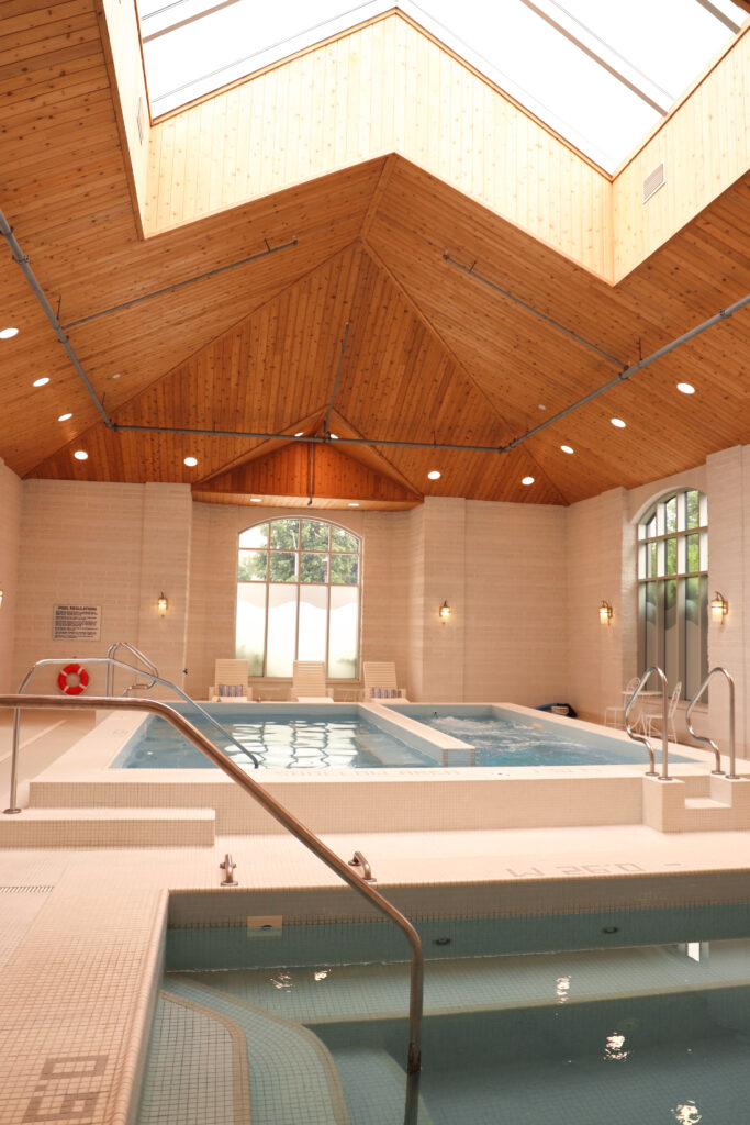 The wheelchair accessible indoor mineral pool with wood vaulted ceiling and handrails at The Bruce Hotel in Stratford, Ontario