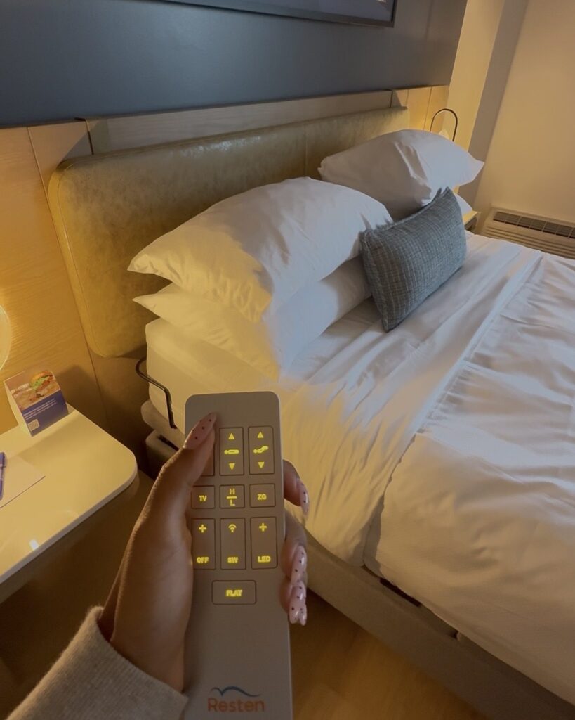 Hand holding the remote control for the adjustable bed in a wheelchair accessible room at Delta Hotels Halifax, Nova Scotia