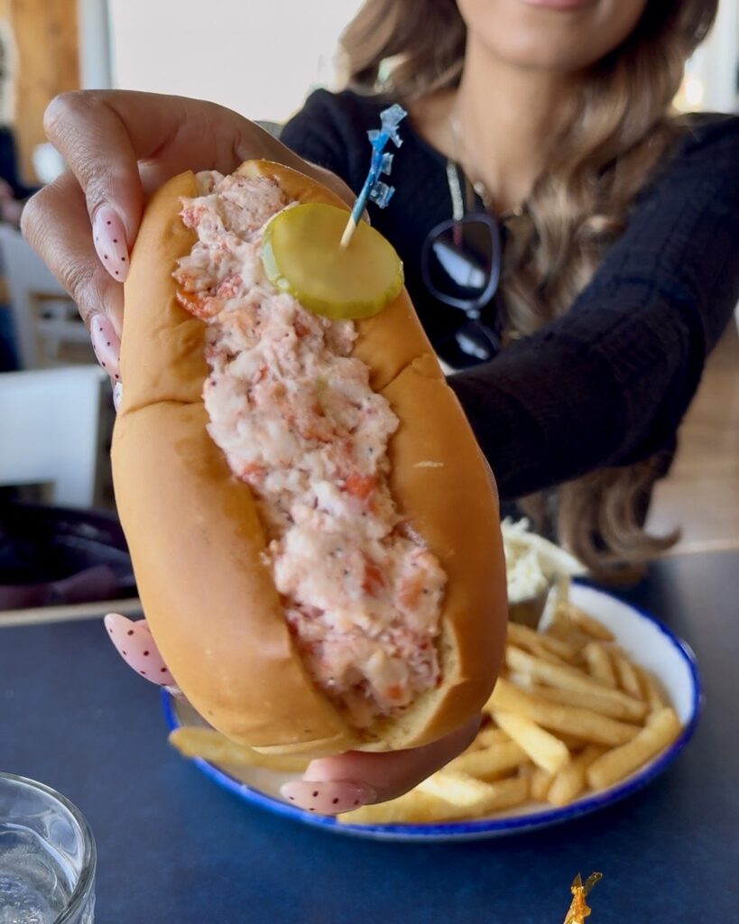 Lobster roll with a pickle and fries at the Sou'Wester restaurant, a lunch spot beside the lighthouse in Peggy's Cove, Nova Scotia